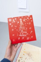 Red advent calendar for chocolate lovers with printed snowflakes, Christmas baking, Haselstaller