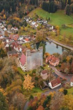 A castle next to a river in the middle of an autumn-colored village, Berneck Castle, Altentsteig,
