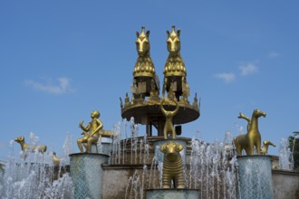 Golden horses and human figures as part of an elaborate fountain with sparkling water, Colchis