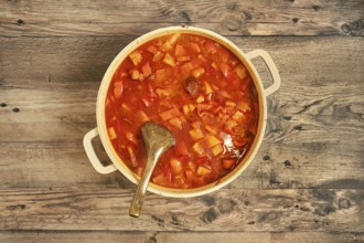 Top view of a hearty beef stew in a large pot, filled with tender beef chunks, colorful vegetables,