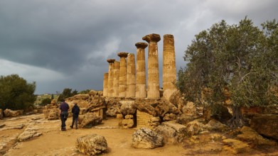 Heracles Temple, Ancient Column Ruins with Two People and Stormy Sky, Valley of the Temples, Valle