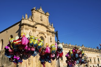 Scigli, Easter Sunday, glowing balloons floating in front of a church, standing out against the