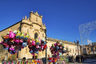 Scigli, Easter Sunday, colorful balloons in front of a church on a busy square with bright blue