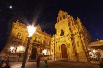 Ragusa, Baroque church illuminated at night, warm lighting effects by street lamp, Baroque towns of