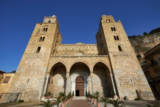 Impressive cathedral with symmetrical towers and arches under clear blue sky, Cefalu, cathedral,