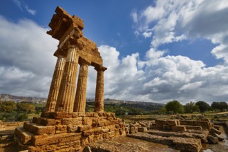 Temple of Dioscuren, ancient temple ruins on a hill under cloudy sky, Valley of the Temples, Valle