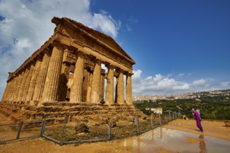 Temple of Concordia, large ancient temple with Doric columns and a person in the foreground, Valley