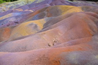 Bright multi-colored mounds of sand that form a wavy pattern. Africa, East Africa, Mauritius,
