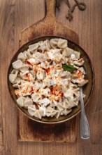 The dish features a generous serving of Turkish dumplings topped with velvety yogurt and a drizzle