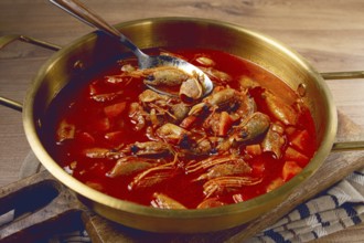 French shrimp bisque soup, in a pot, close-up, no people