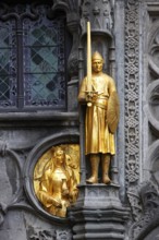 Golden figures on the façade of the St. Ivo Chapel at the Basilica of the Holy Blood, Castle Square