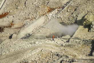 Workers among steaming fumaroles in the Owakudani geothermal area at Komagatake volcano, Hakone,