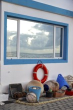 House façade decorated with fishing utensils, white house with blue windows, La Santa, Lanzarote,