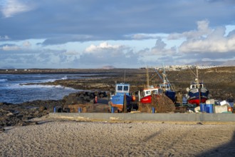 Colourful fishing boats at the port of La Santa, coast with volcanic rocks, La Santa, Lanzarote,