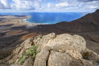 View from the Risco de Famara cliffs to the coast and the sea with the Famara beach, Playa de