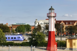 Ystad lighthouse, octagonal iron tower standing between ferry terminal and train station, national