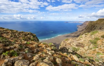 View from the Risco de Famara cliffs to the coast and the sea with the Famara beach, Playa de