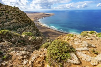 View from the Risco de Famara cliffs to the coast and the sea with the Famara beach, Playa de