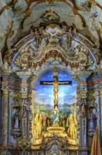 An old Baroque altar with a crucified Jesus, full of colors and images, in the Sanctuary of Bom