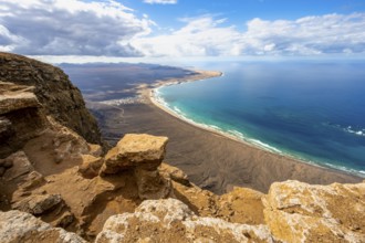 View from the Risco de Famara Cliff to Famara Beach, Playa de Famara with La Calaeta, Lanzarote,