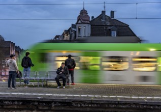 Essen-Steele S-Bahn station, passengers waiting for the train late afternoon, in autumn, Essen,