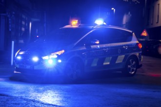 Police patrol car deployed with flashing lights, Essen, North Rhine-Westphalia, Germany