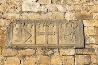 Religious stonework imagery on church wall, Echo or Hecho, Valle de Hecho, Pyrenees Mountains,