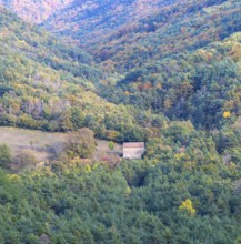 Autumn forested valley landscape with farm barn building near Echo or Hecho, Valle de Hecho, Huesca