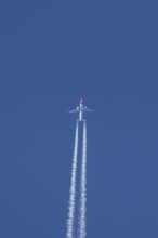 Boeing 737 jet passenger aircraft of Norwegian Air airlines flying in a blue sky with contrails or