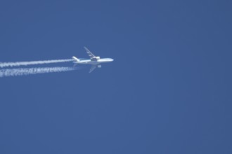 Airbus jet passenger aircraft of Royal Dutch KLM airlines flying in a blue sky with contrails or