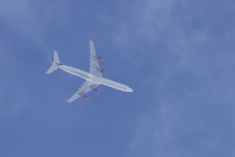 Airbus A340 jet cargo aircraft of European Cargo airlines flying in a blue sky, England, United