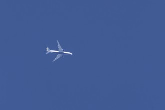 Boeing jet passenger aircraft flying in a blue sky, England, United Kingdom