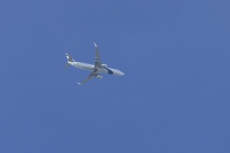 Boeing 737 jet passenger aircraft of El Al Israel airlines flying in a blue sky, England, United
