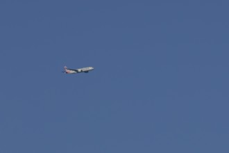 Boeing 777 jet passenger aircraft of American airlines flying in a blue sky, England, United