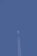Boeing 737 jet passenger aircraft of Norwegian Air airlines flying in a blue sky with contrails or