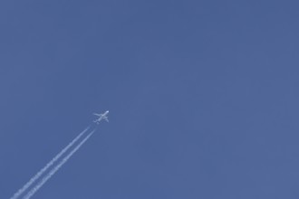Airbus jet passenger aircraft of Eurowings airlines flying in a blue sky with contrails or vapour