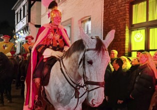 St. Martin on a white horse train in Alte Schulstraße in the evening, Altstadt, Kempen, Lower