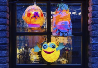 Homemade lanterns for the Martin procession in front of a window in the evening, Old Town, Kempen,