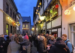 People on the Alte Schulstraße decorated for the Martin train in the evening, Old Town, Kempen,