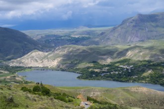 View of a lake nestled in mountainous landscape under cloudy sky, landscape with Shamb Reservoir