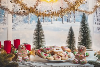 Christmas table with cookies and decorations in front of snow-white landscape