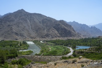 A river snakes through a lush landscape with mountains, views of Iran, Aras River near Meghri,
