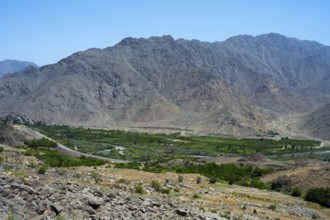 A vast valley with green vegetation surrounded by dry mountains, views of Iran, Aras River near