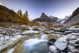 Mountain stream with autumnal larches and mountain views, Mont Mine, Ferpecle glacier, Val
