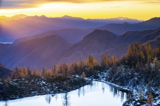 Laghetto dei Saléi mountain lake with autumnal larches (Larix) at sunrise, Onsernone Valley, Canton
