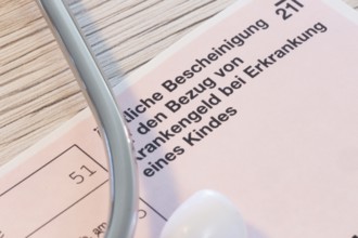 Close-up of a medical certificate for receiving sickness benefit if the child is ill