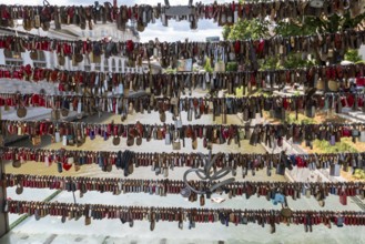 Love locks hang in several rows on the railing of the Mesarski Most (butcher's bridge) over the