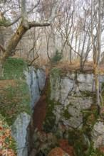 Low sun illuminates the rocks and caves of hell holes in the autumnal landscape of Dettingen an der