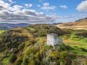 Autumn colours over Castell Dolwyddelan and Eryri Mountains from a drone, Snowdonia, Conwy County
