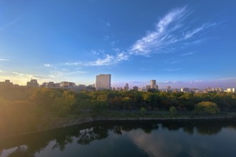 Japan, panoramic view of Osaka skyline from Osaka castle at sunset